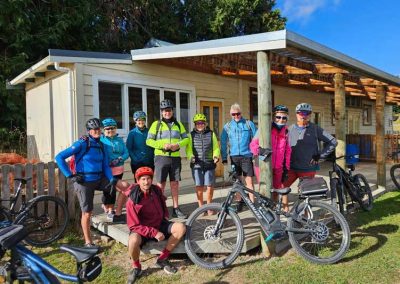 A group of cyclists gathered outside Pukeokahu Hall on the second day of riding on a Tussock to Dune Cycle adventure.